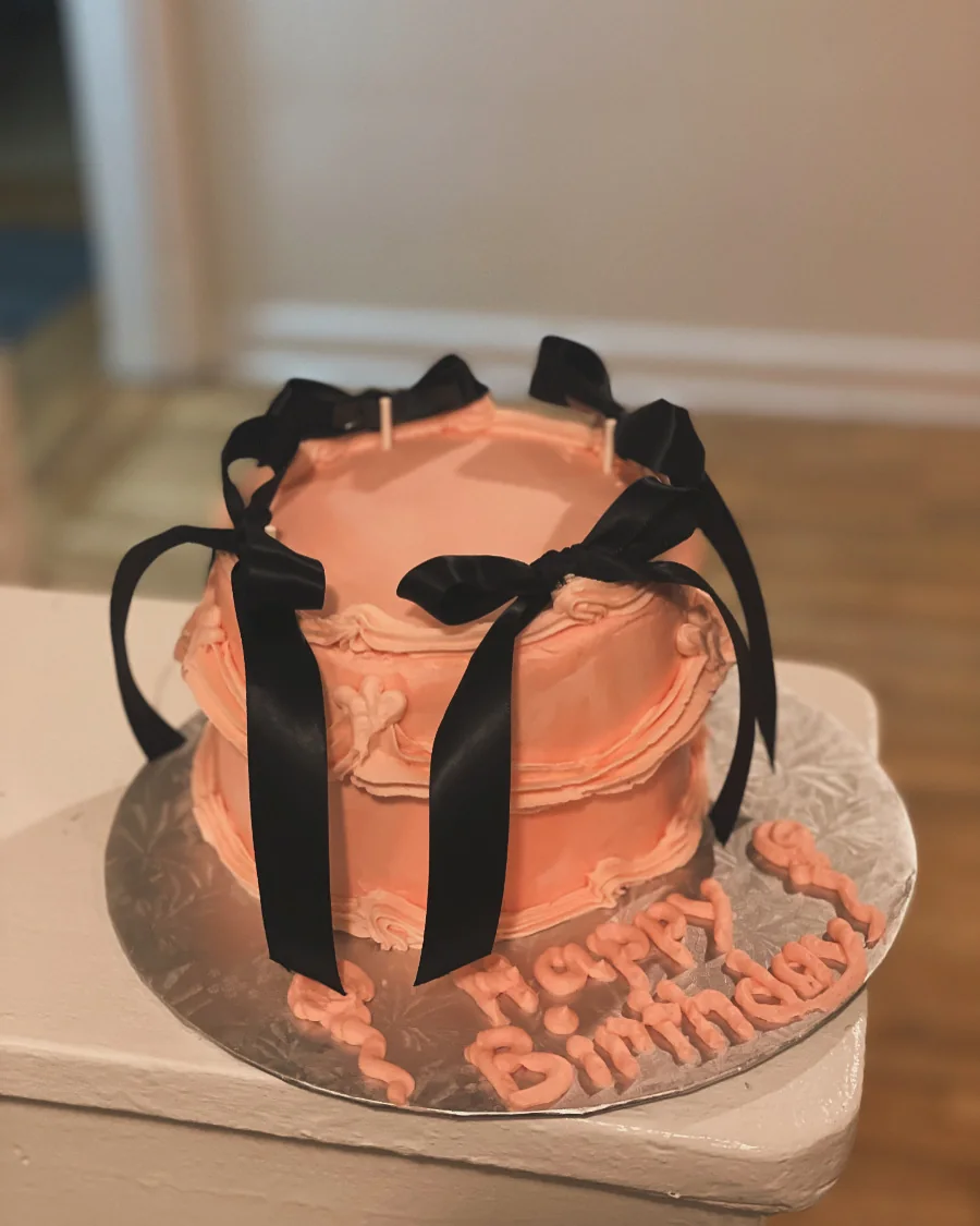 Peach vintage cake decorated with black bows and piped borders