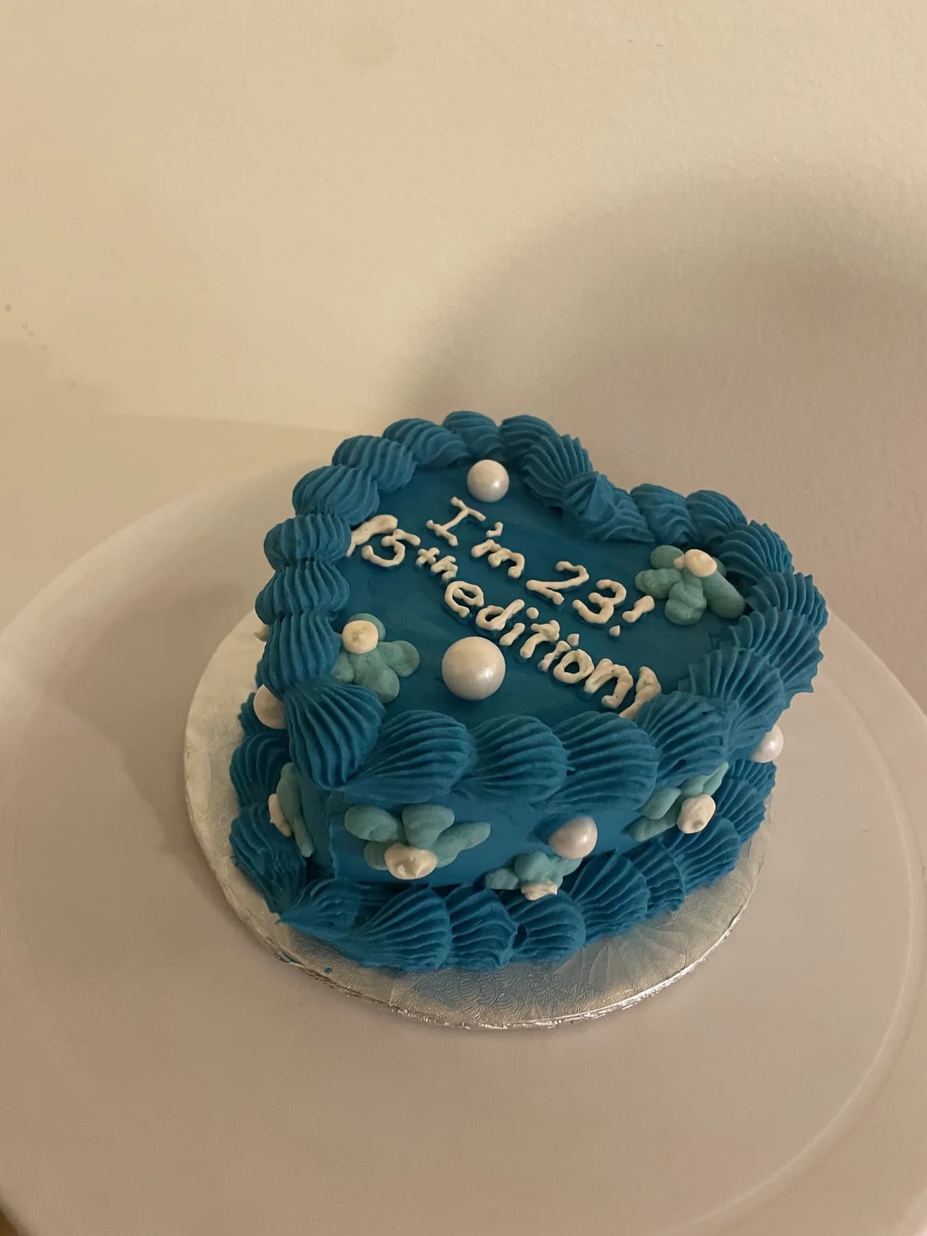 Deep blue bento cake with piped borders and pearl details