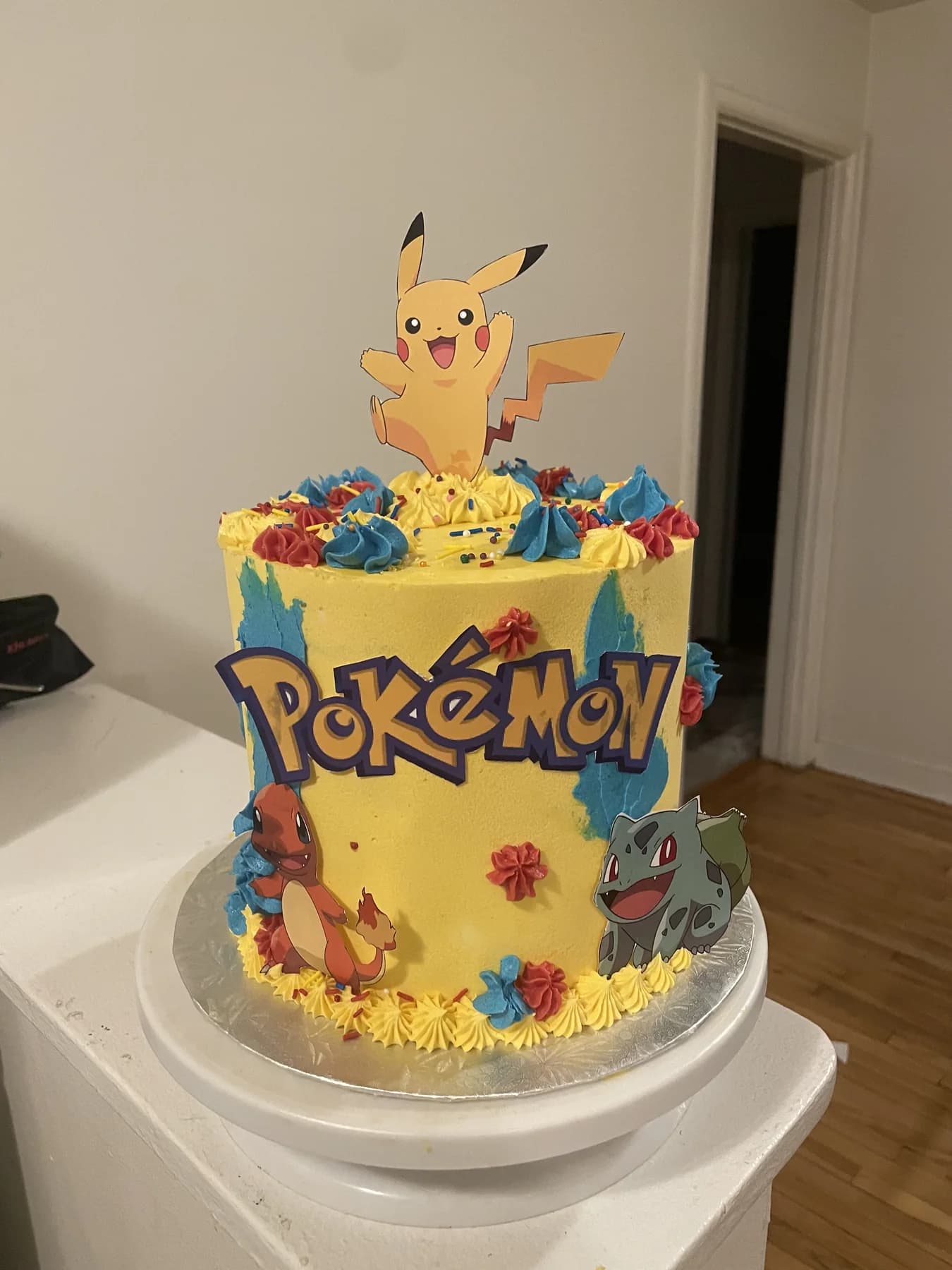 Tall yellow Pokemon cake with colorful buttercream details