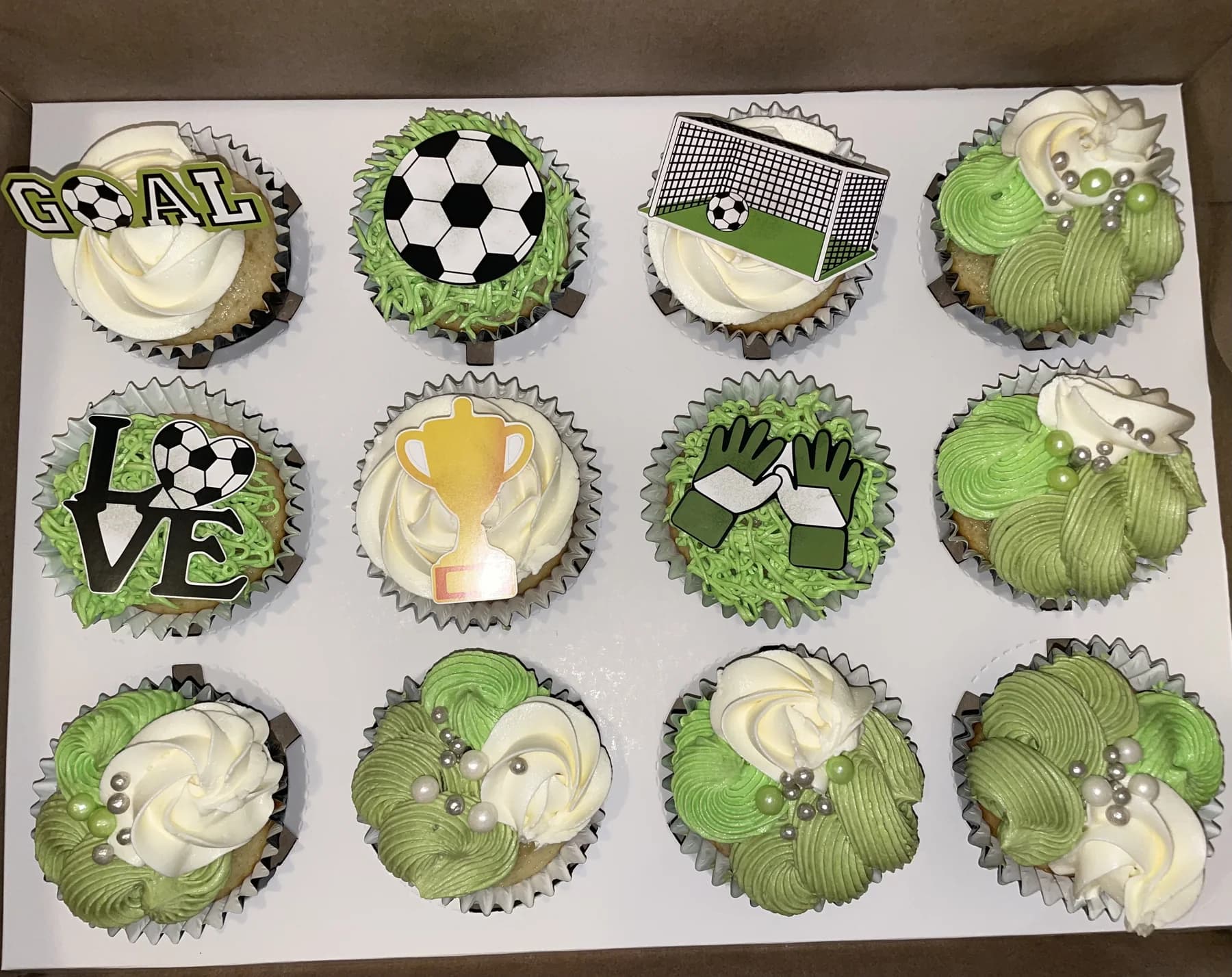 Custom green and white soccer cupcakes in a presentation box